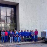 Group image of a portion of Eastern Lift Truck Co.'s Montville team standing outside their facility.