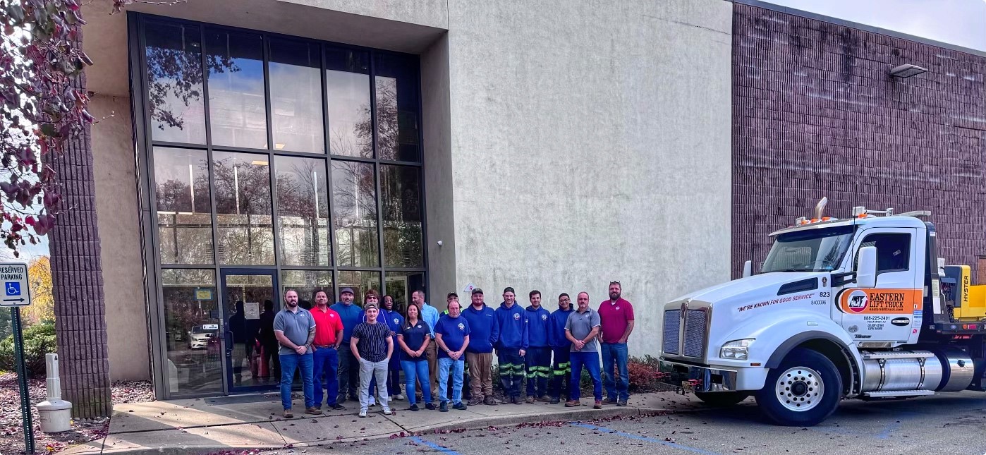 Group image of a portion of Eastern Lift Truck Co.'s Montville team standing outside their facility.